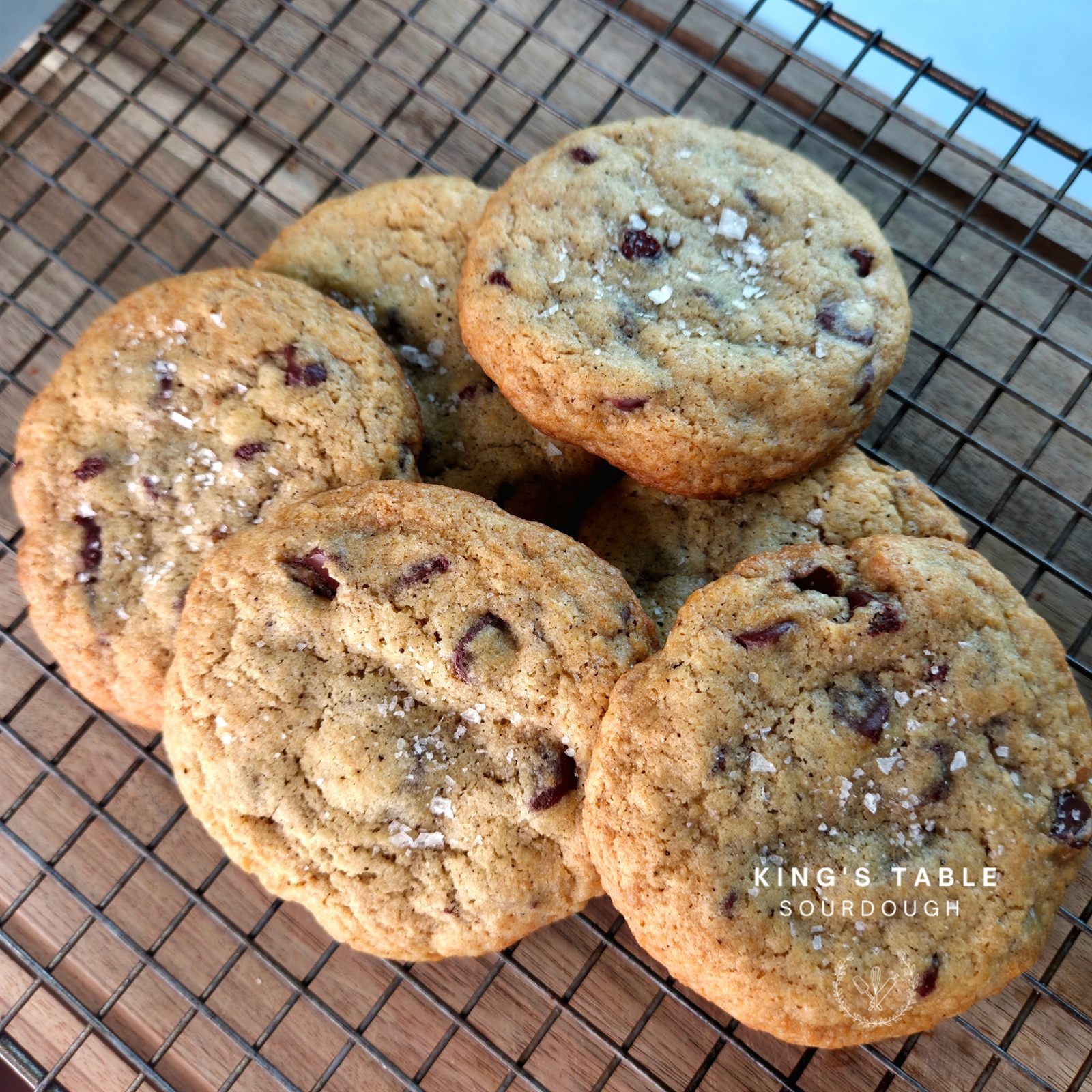 Browned butter chocolate chip sourdough cookies topped with flaky sea salt